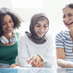 Close Up Portraits Of Three Smiling Teenage Girls. Muslim In A H